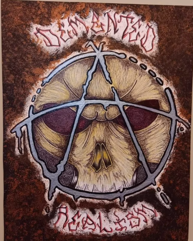 A stylized skull with a pentagram superimposed over its eyes, set against a rusted background with the word 'DEMANTED' in red at the top.